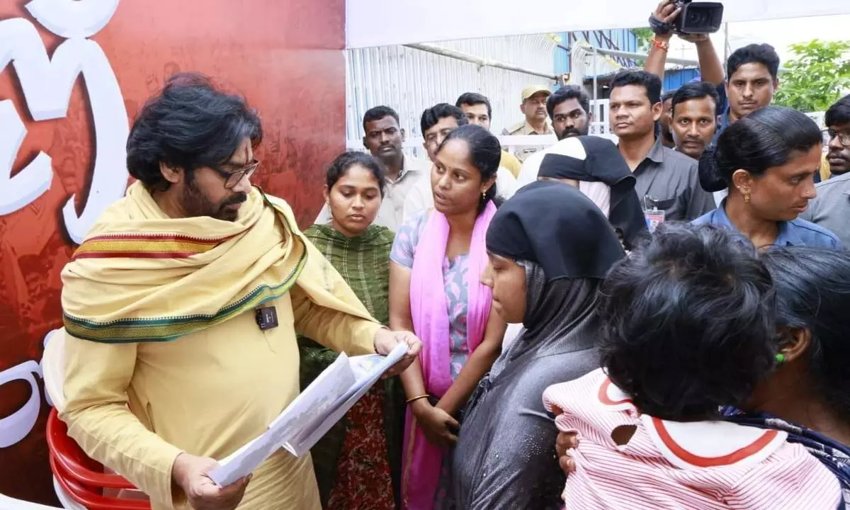 Residents of Kummaripalem of Vijayawada city submitting a memorandum to Deputy Chief Minister K Pawan Kalyan at his camp office in Mangalagiri on Friday