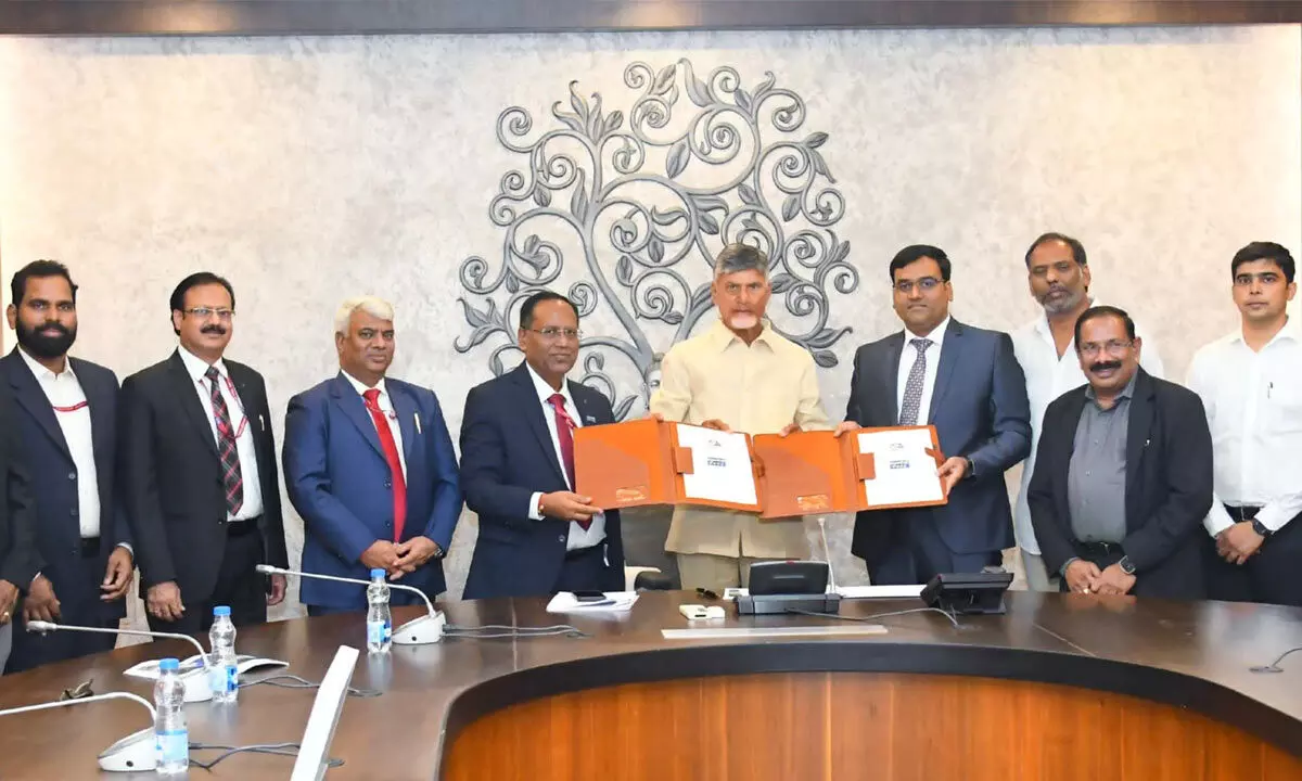 APGenco and NHPC officials exchanging documents of joint venture in the presence of Chief Minister N Chandrababu Naidu at the Secretariat on Friday