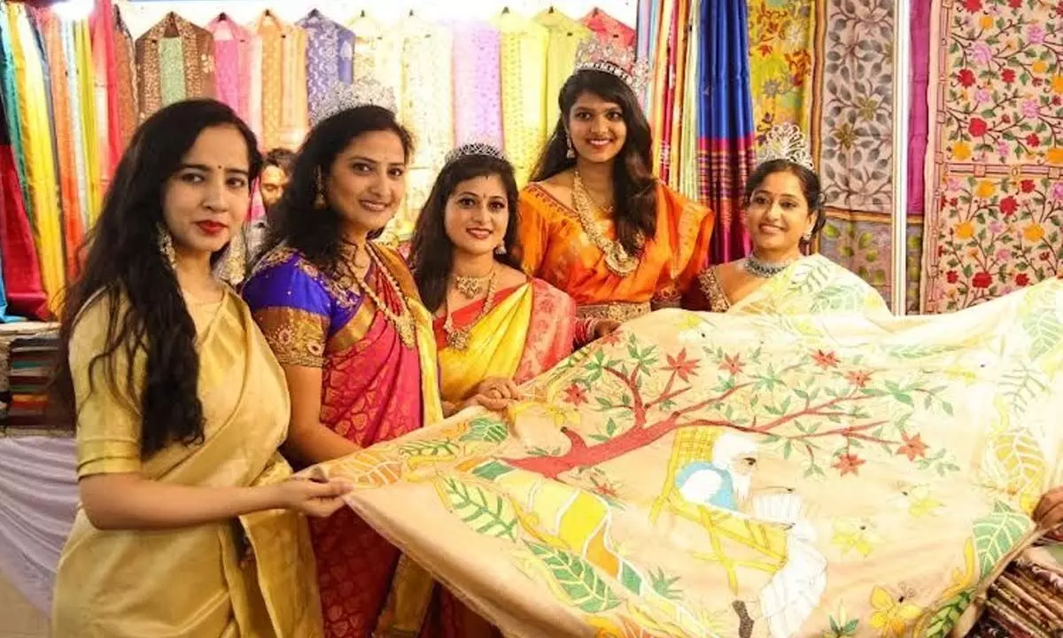 Women looking at the handloom sari put up at the exhibition organised by the Indian Silk Gallery at Symphony Hall, RK Beach, in Visakhapatnam