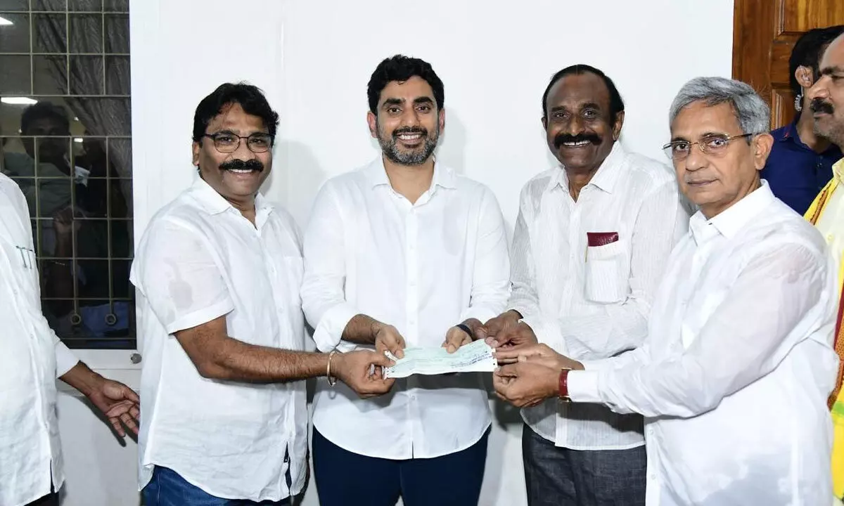 Lendi Engineering College management handing over DD for Rs 5 lakh toward flood relief to HRD minister Nara Lokesh in Visakhapatnam on Friday