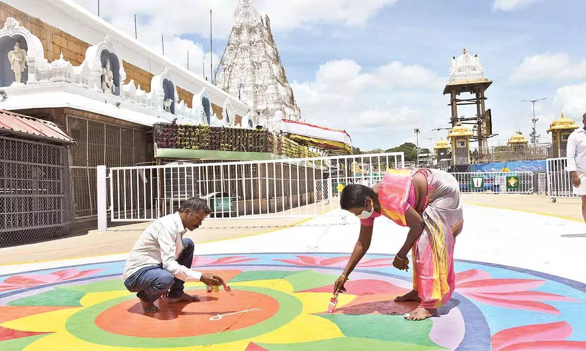 Mada streets at Tirumala are being decorated with colourful Rangolis