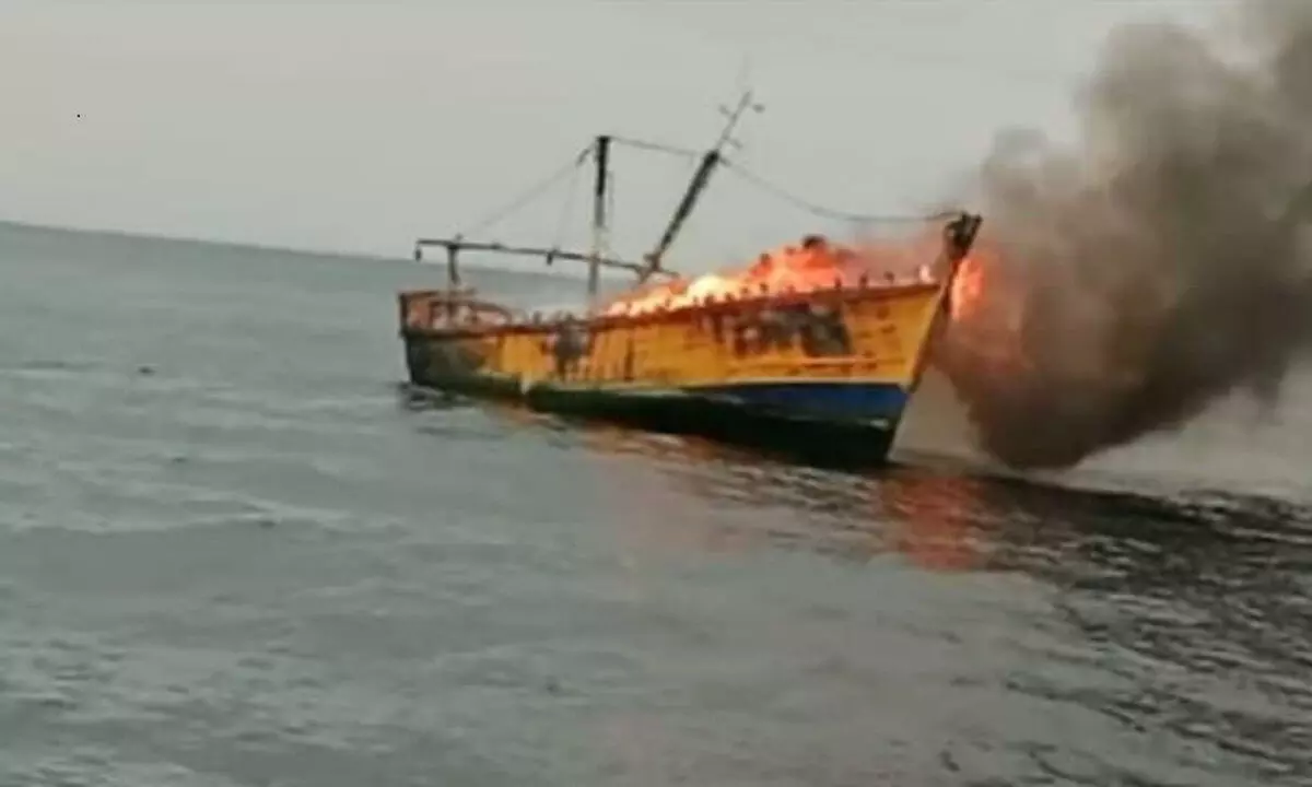 A mechanised boat which caught fire in the middle of the sea in Visakhapatnam on Sunday