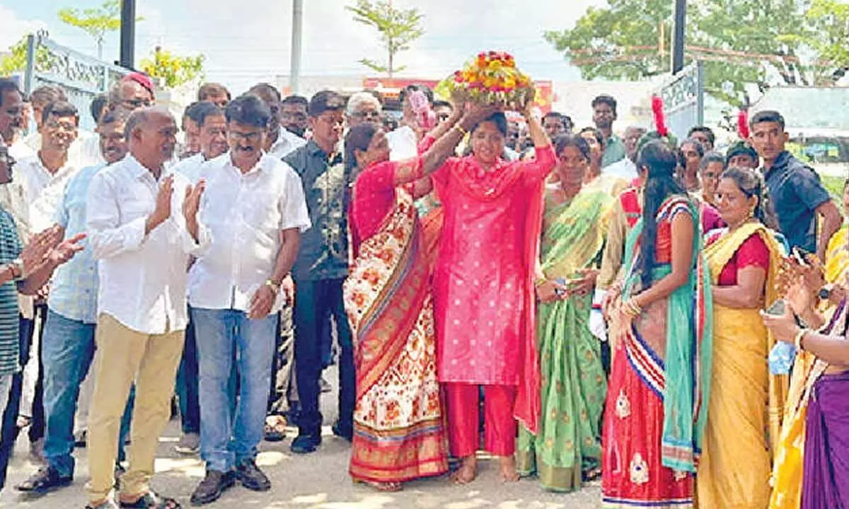 Narayanpet MLA Dr Parnika Reddy carrying Bathukamma on her head during a festival procession on Tuesday