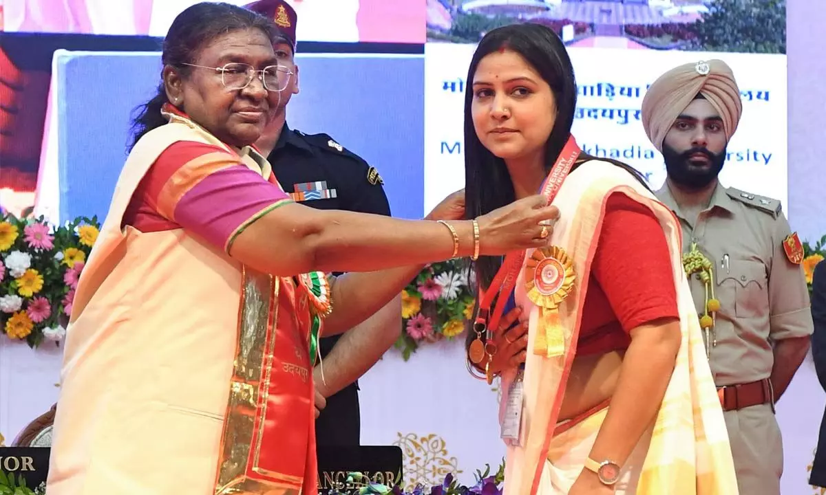 President Droupadi Murmu honours a student during the 32nd convocation of Mohanlal Sukhadia University, in Udaipur on Thursday