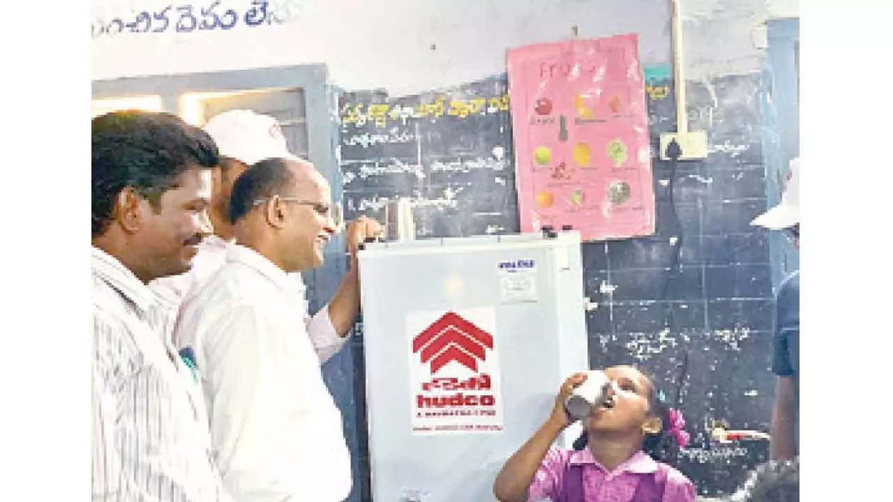 HUDCO regional head BSA Murthy at the water cooler at mandal parishad school at Gurivindapalli in Krishna district on Wednesday