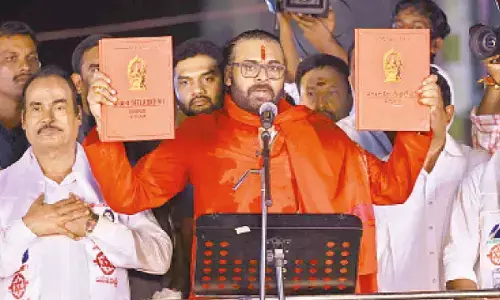 Deputy CM Pawan Kalyan displaying Varahi Declaration books in Tirupati on Thursday