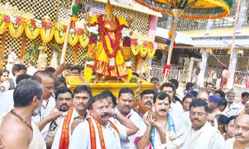 Commissioner of police S V Raja Sekhara Babu, EO K S Rama Rao, priests  and others carrying Goddess Kanaka Durga Utsava idol at the start of 9-day Dasara celebrations atop Indrakeeladri on Thursday  		 (Photos: Ch Venkata Mastan )