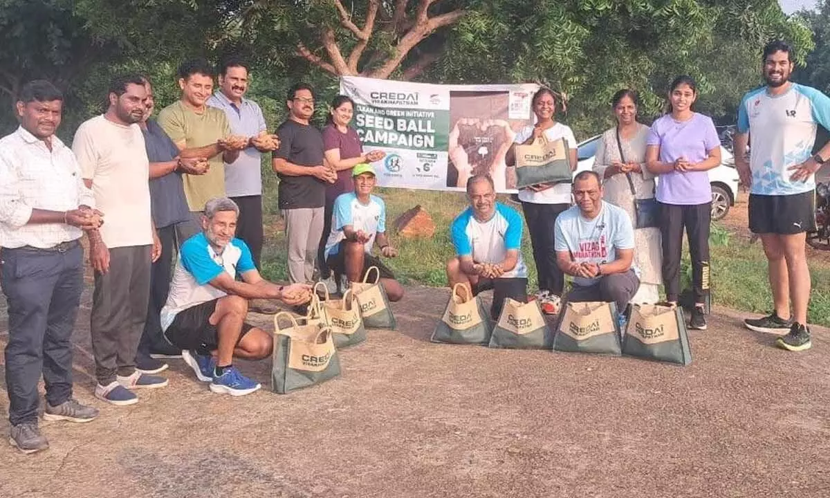 Members of Visakhapatnam chapter of CREDAI with seed balls in Visakhapatnam on Sunday