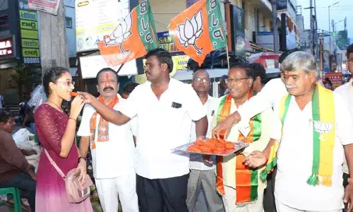 BJP activists distributing sweets in Tirupati on Tuesday