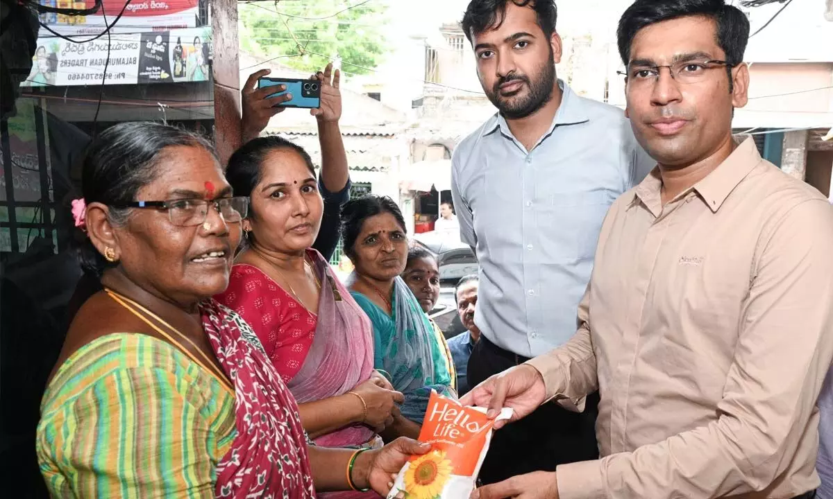 District Collector Dr S Venkateswar distributing sunflower oil packet to a customer in Tirupati. Joint Collector Shubham Bansal is also seen.