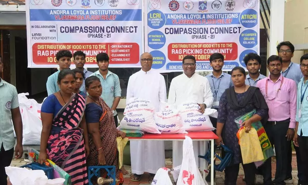 Andhra Loyola Institutions in association with NGOs distributing flood relief kits to rag-pickers in Vijayawada on Friday