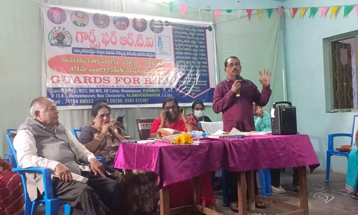 Varda Nageswara Rao, national convener of Guards for RTI, speaking at the 19th annual RTI celebration meeting in Rajamahendravaram. District ICDS Officer K Vijaya Lakshmi and Retired Magistrate Vempati Viswanadham are also seen.