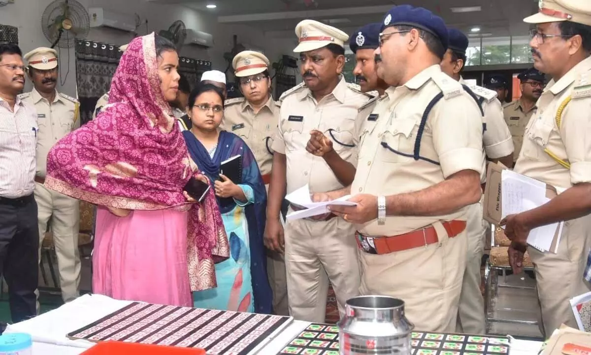 Excise officials explaining collector A Thameem Ansariya on arrangements for lottery process for liquor shops at Ambedkar Bhavan in Ongole on Monday