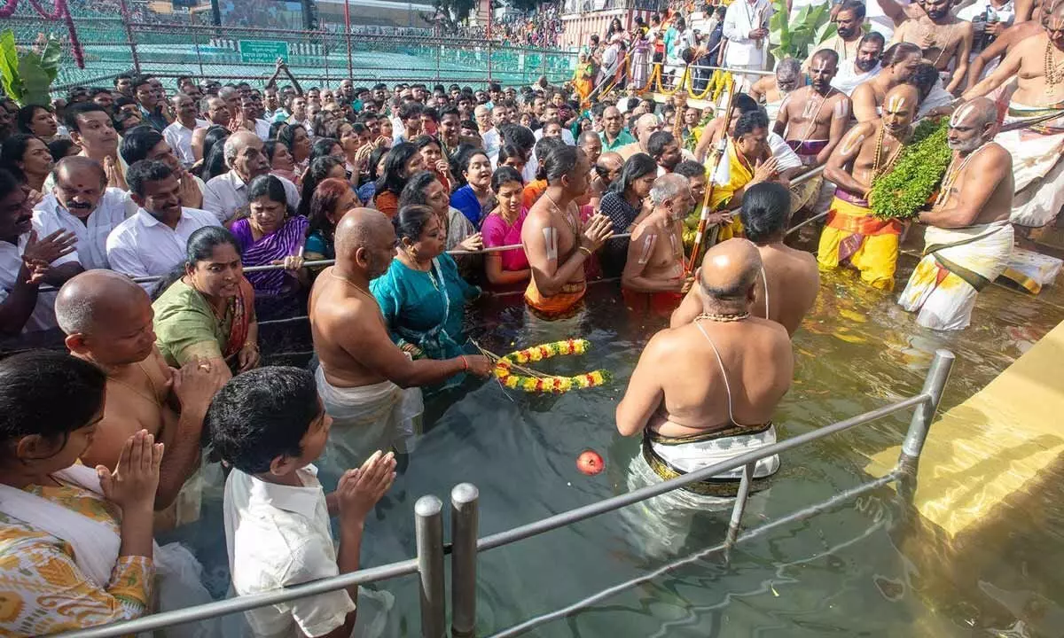 Priests performing Chakra Snanam at Pushkarini at Tirumala on Saturday morning