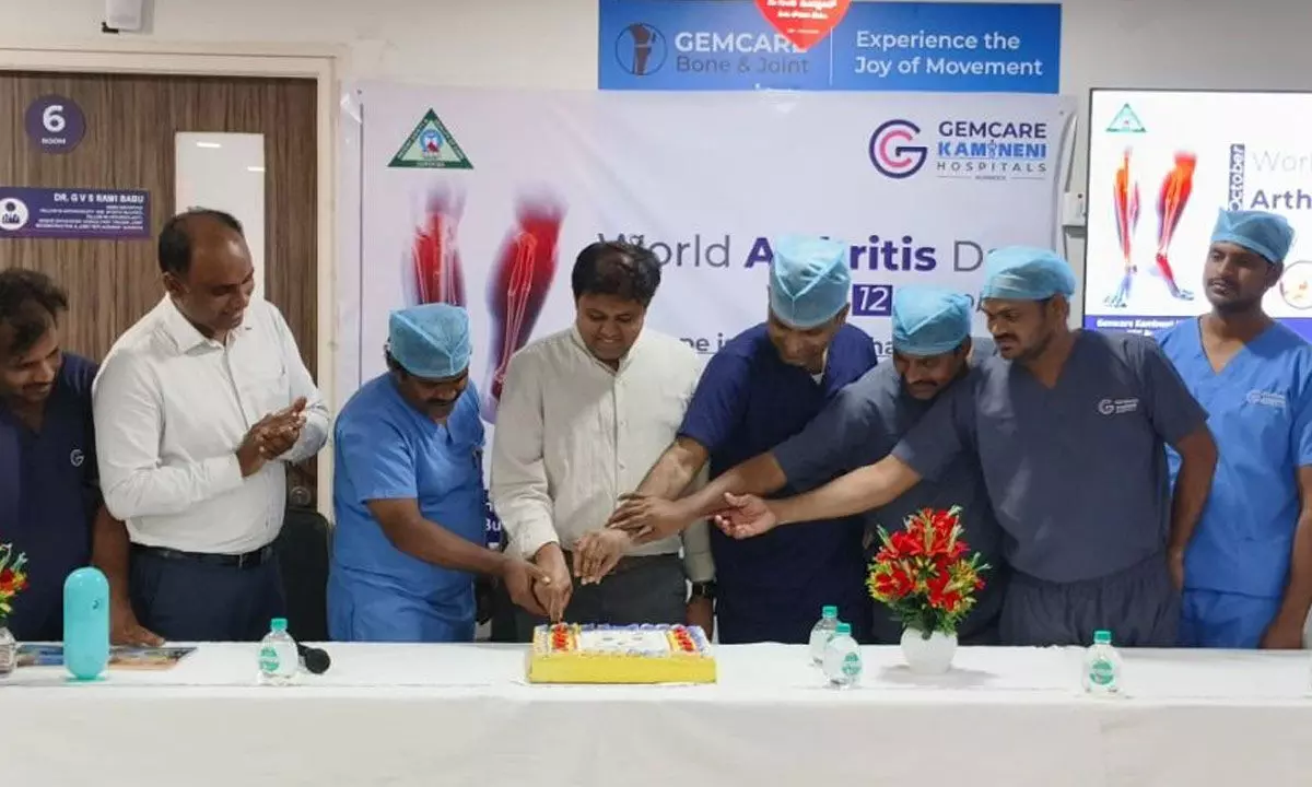 Doctors and others cutting a cake on World Arthritis Day at Gemcare Kamineni Hospitals in Kurnool on Saturday