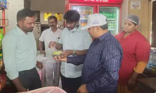 As part of Swachh Aahaar, health officer Dr Vinay Kumar testing food quality at Kurnool railway station on Tuesday. Health inspector G Vijay Kumar is also  seen.