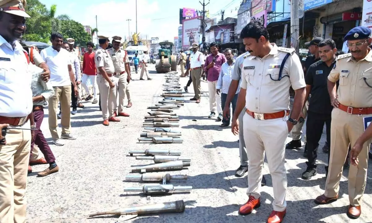 Prakasam SP A R Damodar inspecting the seized modified silencers of motorbikes in Ongole on Friday