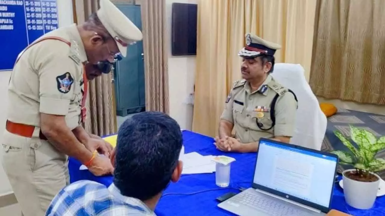 Police commissioner Shanka Brata Bagchi verifying records at a police station at midnight in Visakhapatnam