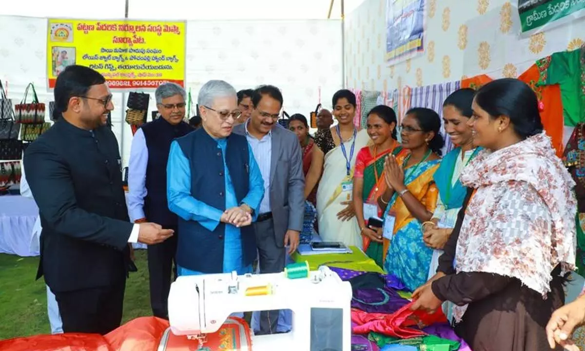 Governor Jishnu Dev Varma interacting with SHG women during his visit to the exhibition stalls at the Collectorate in Suryapet