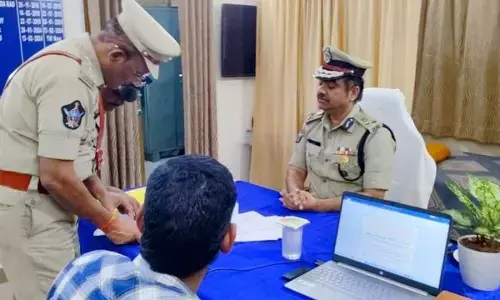 Police commissioner Shanka Brata Bagchi verifying records at a police station at midnight in Visakhapatnam