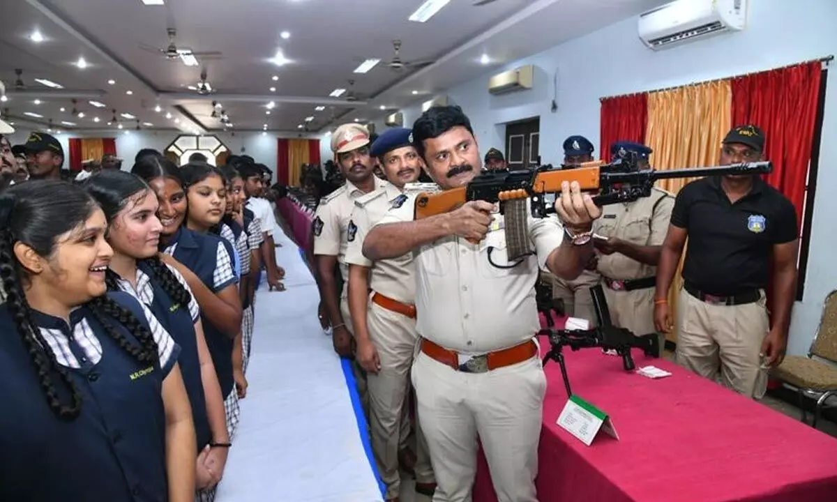 SP AR Damodar demonstrating the functioning of a gun at an Open House organised by Prakasam police in Ongole on Friday