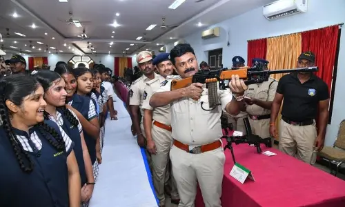 SP AR Damodar demonstrating the functioning of a gun at an Open House organised by Prakasam police in Ongole on Friday
