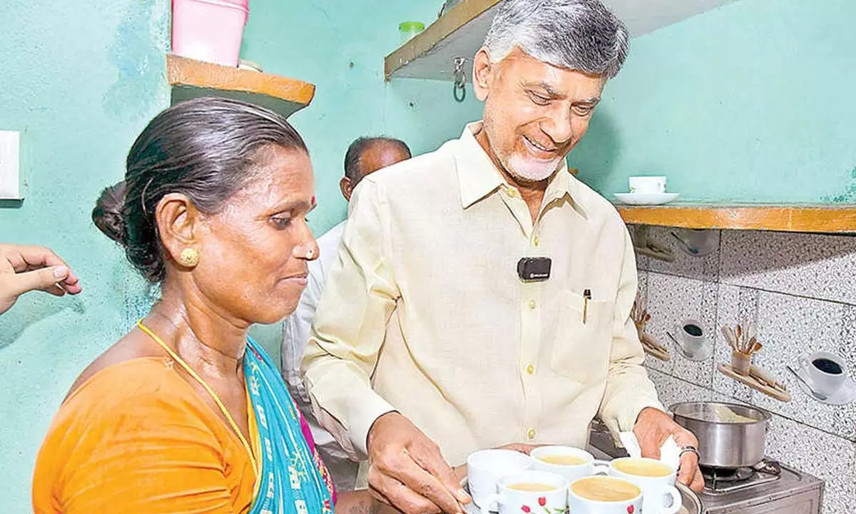 Chief Minister N Chandrababu Naidu serves tea at the home of a beneficiary during the launch of the Deepam - 2, a free cooking gas cylinder distribution scheme, at Eedupuram village in Srikakulam district on Friday