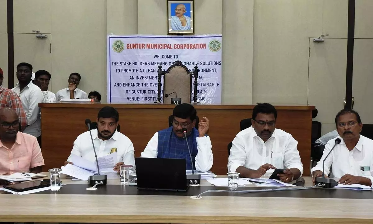 GMC Commissioner Puli Srinivasulu addressing the stakeholders meeting at the GMC office in Guntur on Friday. Mayor Kavati Siva Naga Manohar Naidu is also seen.