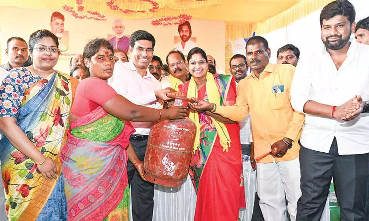 District Collector S Venkateswar and MLA N Vijaya Sri distributing gas cylinder to a beneficiary at Tada of Sullurpet constituency on Friday