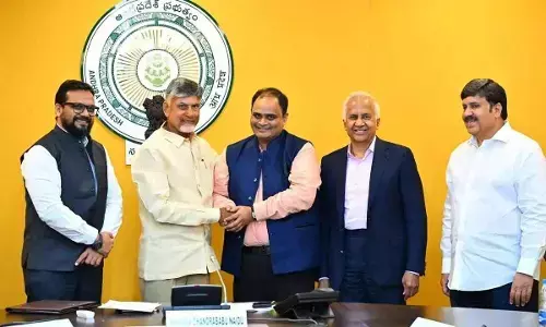 Chief Minister N Chandrababu Naidu with the representatives of Reliance Industries Limited and government officials exchanging copies of the MoU in Amaravati on Tuesday.