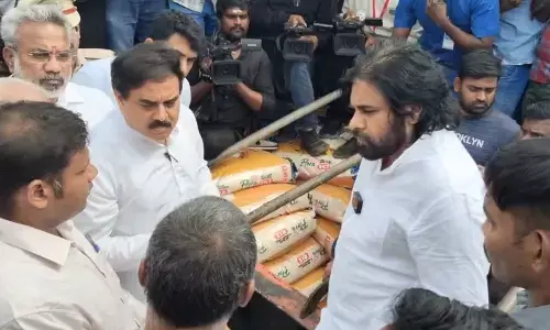 Deputy Chief Minister K Pawan Kalyan speaking to officials during his visit to the Kakinada port on Friday. Civil Supplies Minister Nadendla Manohar and MLA Vanamadi Kondababu are also seen.