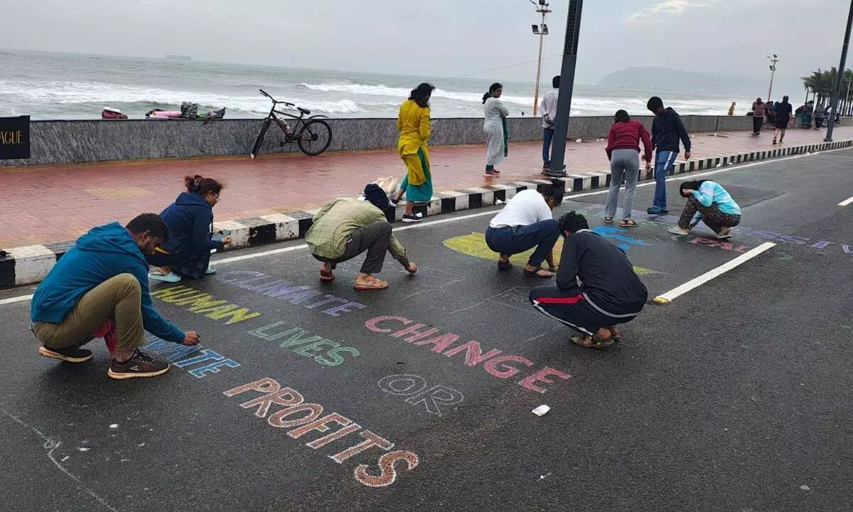 Participants drawing pictures at the beach road in Visakhapatnam on Sunday