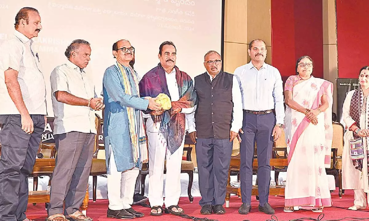 AP Tourism RD R Ramana Prasad felicitating Tirupati MLA Arani Srinivasulu on Sunday. SV University V-C Prof Ch Appa Rao and others are also seen.