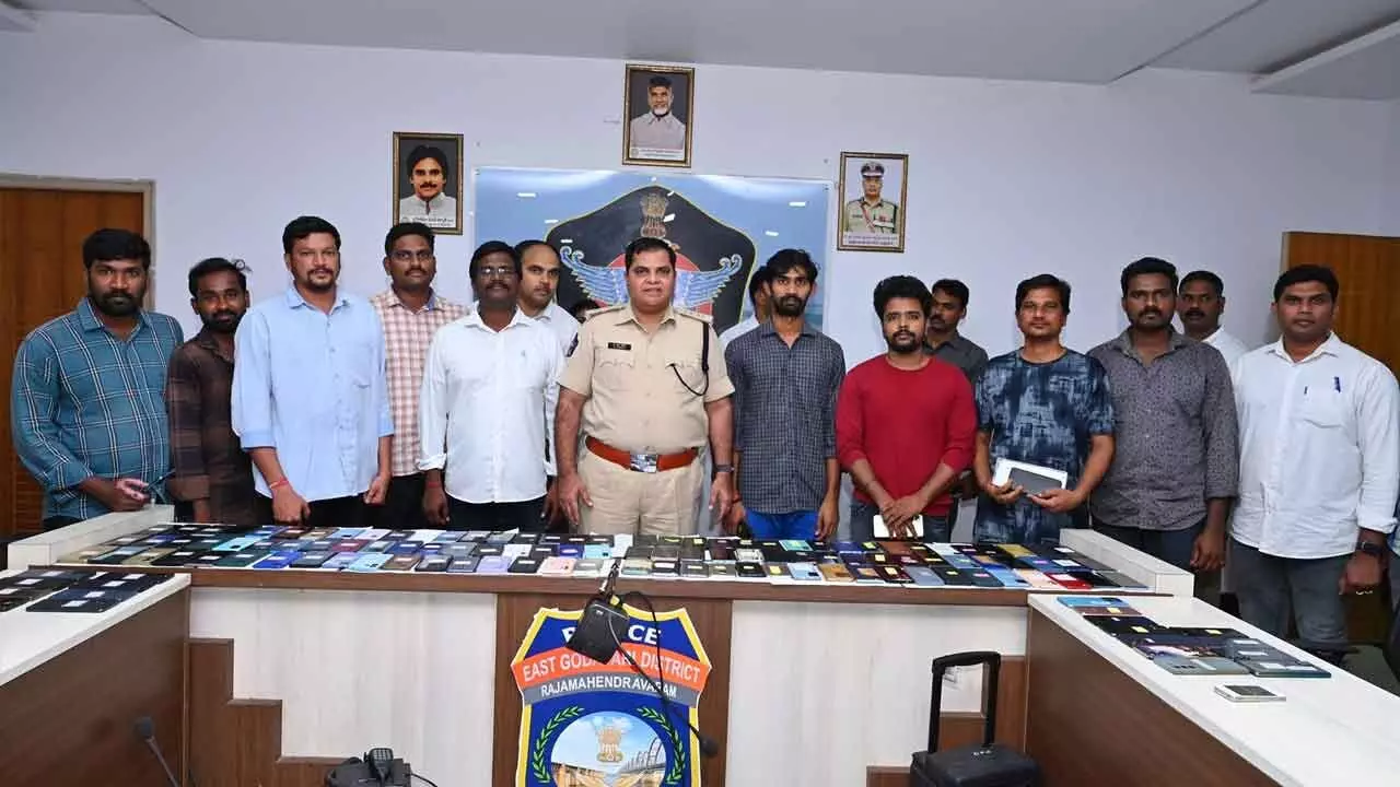 East Godavari district SP D Narasimha Kishore displaying the recovered phones with their rightful owners at a special programme