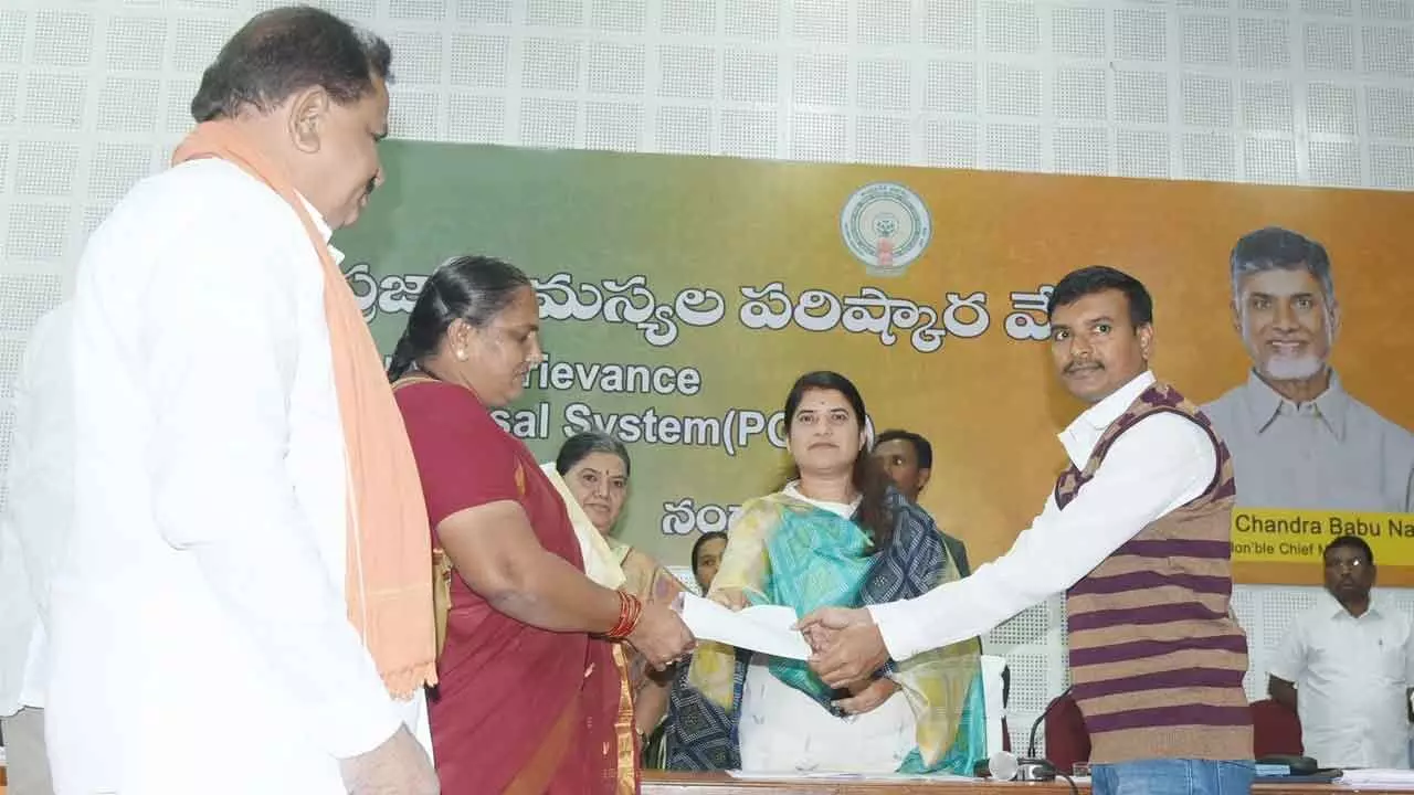 District Collector G Raja Kumari handing over the land documents to the owner in Nandyal on Tuesday