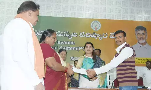 District Collector G Raja Kumari handing over the land documents to the owner in Nandyal on Tuesday