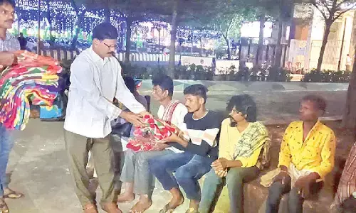 Swarnandhra organiser Gubbala Rambabu distributing blankets to the homeless