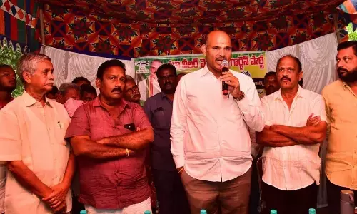 Minister Kolusu Parthasarathy speaking at a meeting in Nuzvid on Sunday