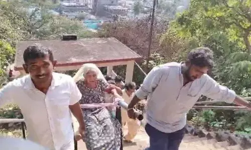 Son carries mother in a doli to fulfil her wish to visit Narsanna Swamy temple