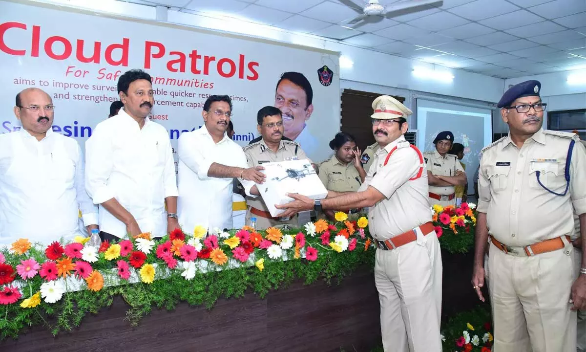 Vijayawada MP Kesineni Sivanath handing over drones to police personnel in Vijayawada on Sunday