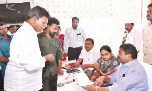Minister DSBV Swamy receiving petitions from the public at the Revenue Sadassu organised in Valluru of Tangutur mandal on Tuesday