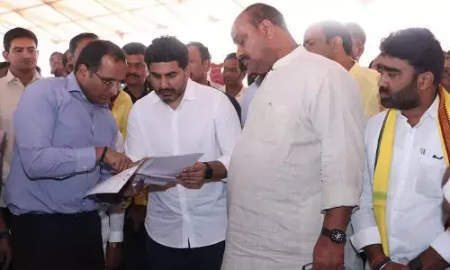 HRD Minister Nara Lokesh, Agriculture Minister K Atchannaidu and Collector M N Harendhira Prasad at the AU Engineering College Grounds examining the arrangements for the PM’s visit in Visakhapatnam on Sunday
