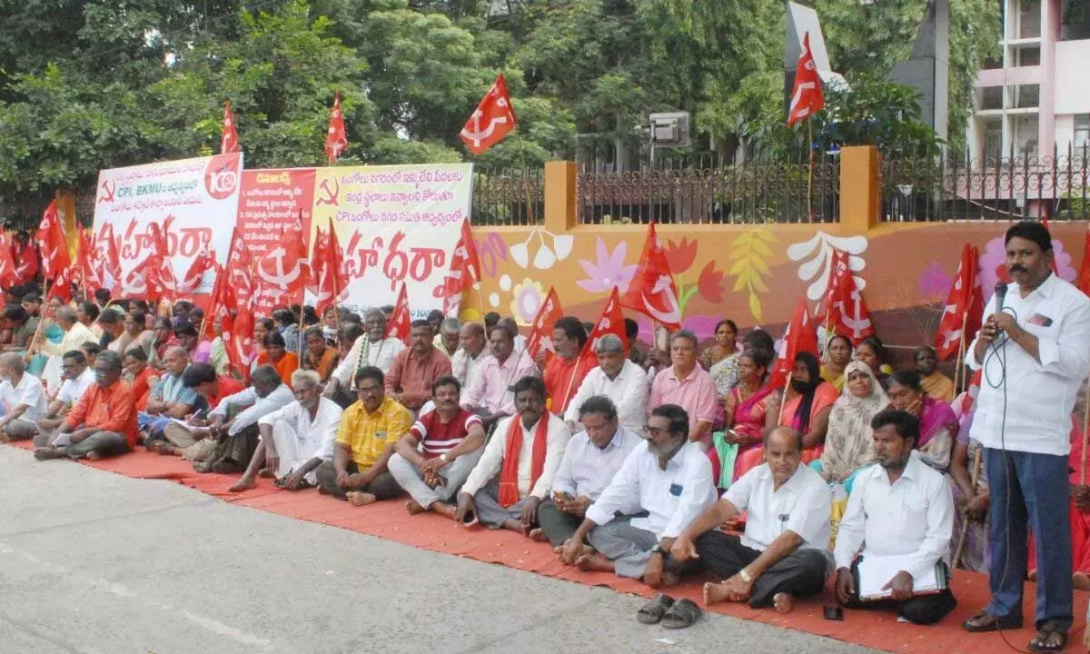 CPI Prakasam district secretary M L Narayana speaking at a protest in front of the Col-lectorate in Ongole on Friday