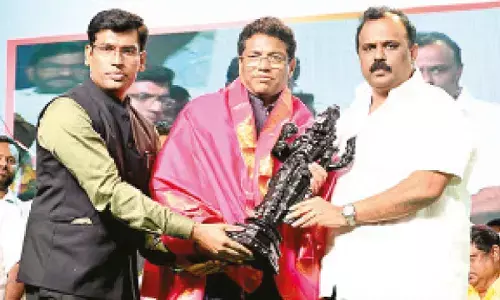 Revenue Minister Anagani Satya Prasad felicitating Sri City MD Ravindra Sannareddy. District Collector S Venkateswar is also seen.