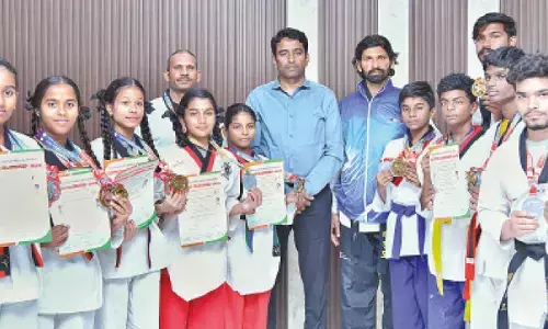 Collector Lakshmisha pats taekwondo champions