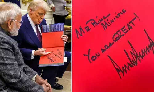 Prime Minister Modi during a meeting with President Trump. (R) The message written by the US President in a book which he presented to PM Modi at the White House in Washington