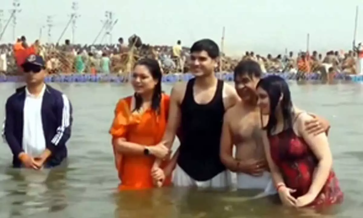 Assam CM, family take holy dip at Sangam
