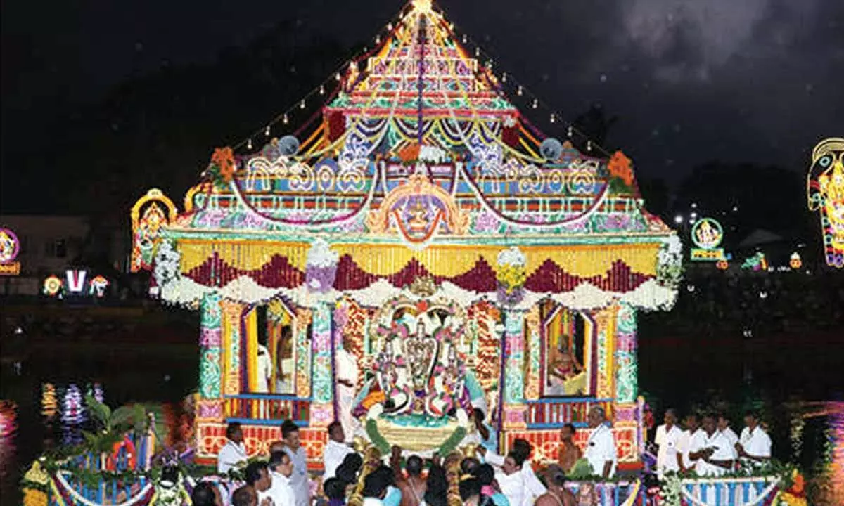 Lord blesses devotees during Teppotsavam Lord blesses devotees during Teppotsavam
