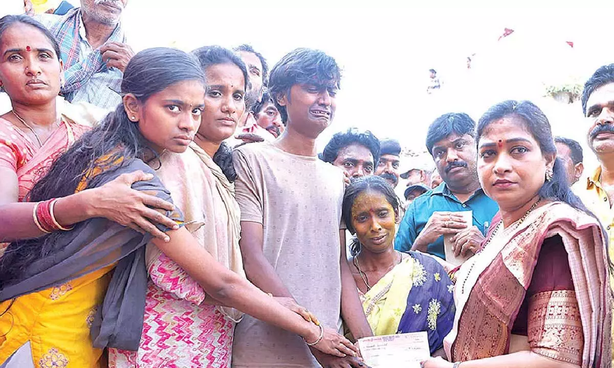 Home Minister distributes compensation cheques Home Minister distributes compensation cheques