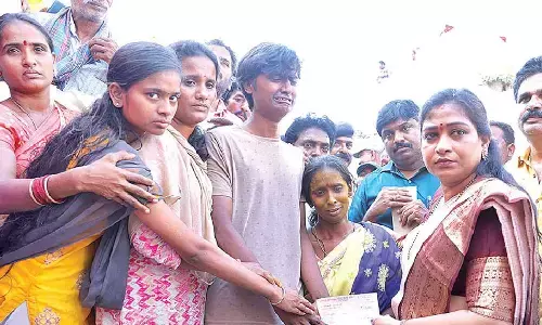 Home Minister distributes compensation cheques